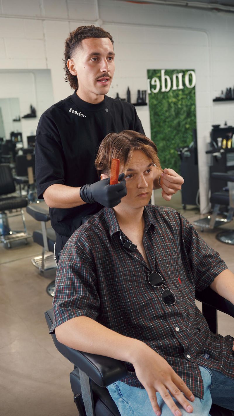 A Sonder barber consulting a client